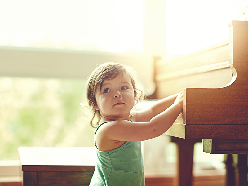 girl toddler playing piano