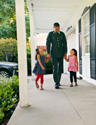 military dad walking with daughters